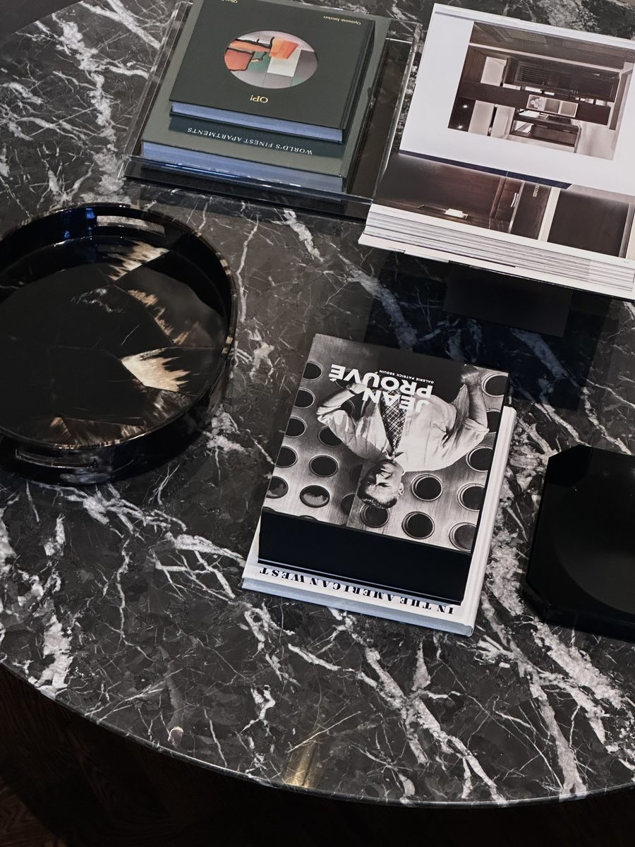 Black marble coffee table with books and horn tray