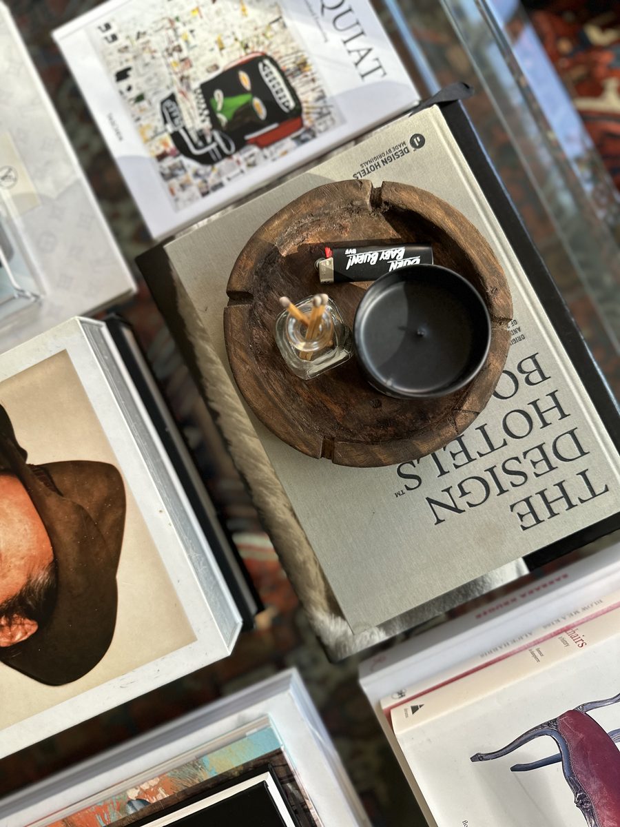 Glass coffee table with books, candles and design objects