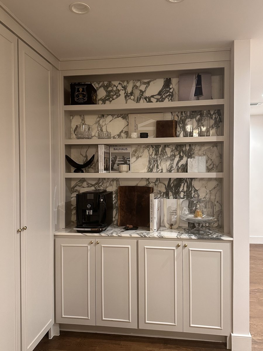 Full built-in bar and shelving with marble backsplash