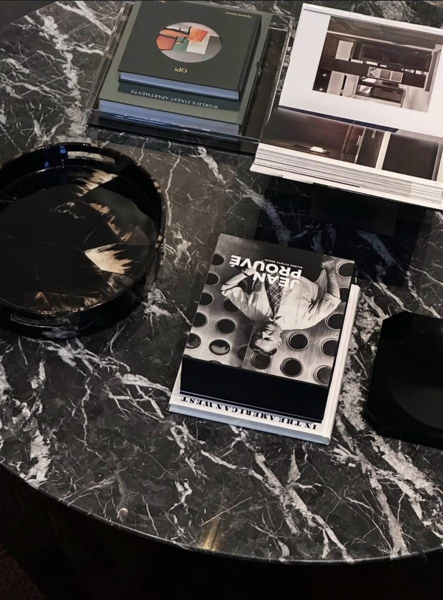 Black marble table with Jean Prouve books and horn tray