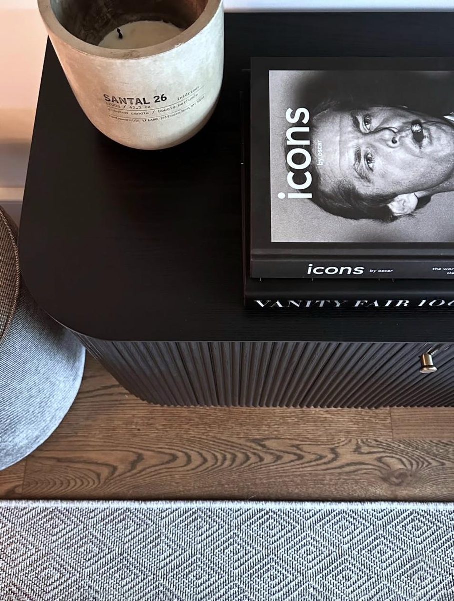 Black nightstand with Icons by Oscar books and Santal candle